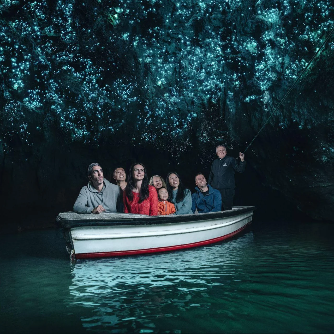 Vanuit een bootje kijken naar de glimwormen in de grotten van Waitomo